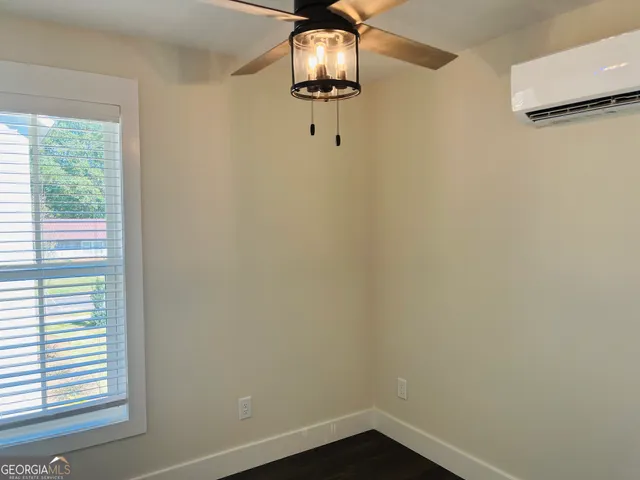 a view of a room with a air conditioner and window