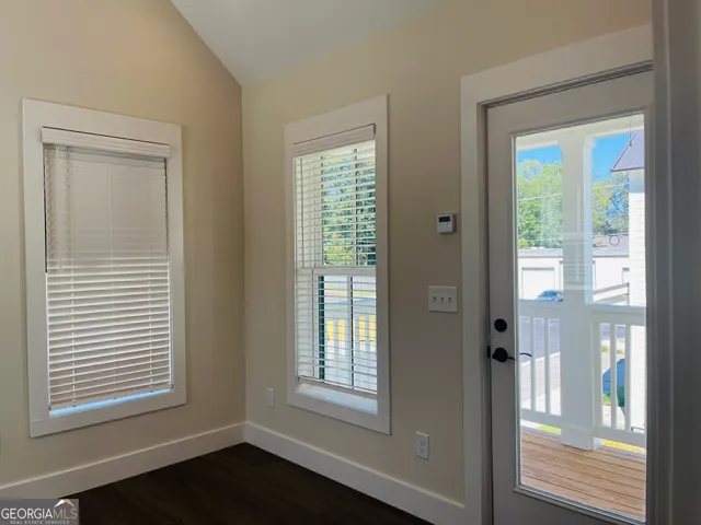 an empty room with wooden floor & closet