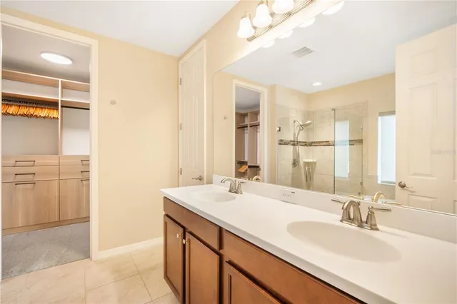 a bathroom with a double vanity sink mirror and