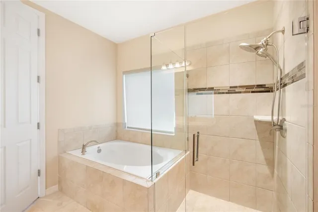 a bathroom with a tub and shower