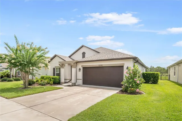 a front view of a house with a yard and garage