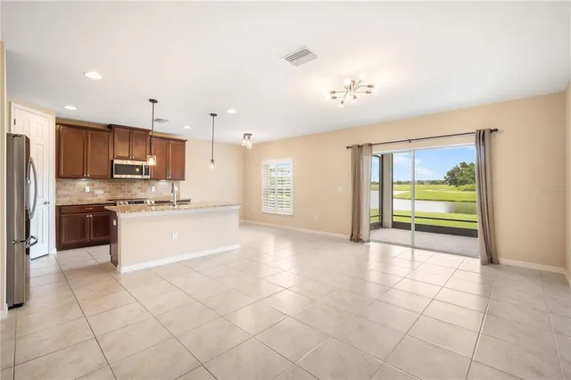 a large kitchen with stainless steel appliances granite countertop a stove and a refrigerator