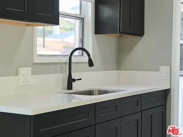 a kitchen with a sink and a window
