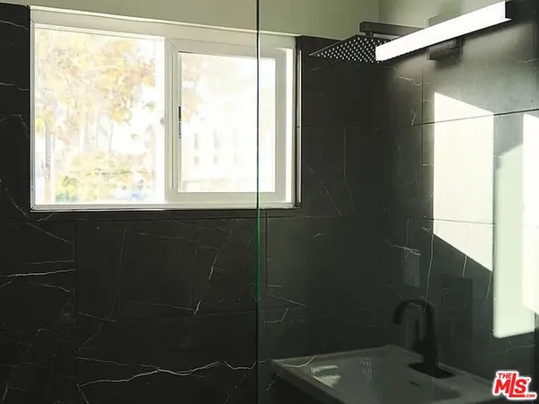 a bathroom with a window and a shower