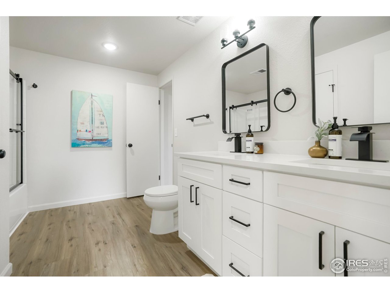1356 Emery Street Longmont, CO 80501 - Photo 15 of 24 a bathroom with a double vanity sink mirror and toilet
