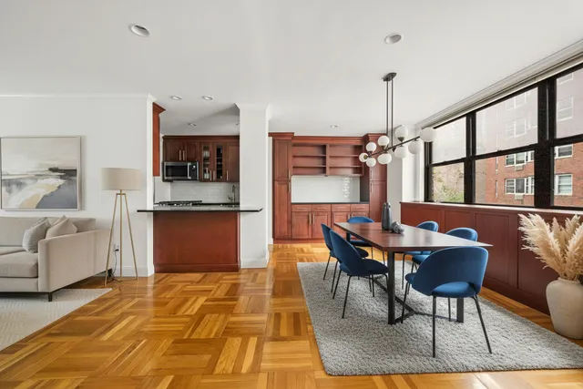 a dining room with furniture and a rug