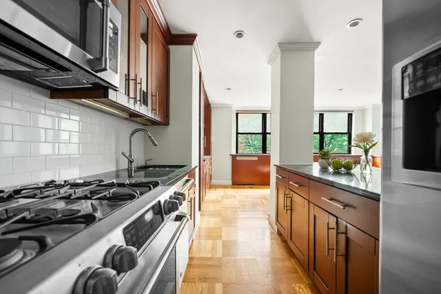 a kitchen with stainless steel appliances granite countertop a stove and a sink