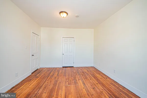 a view of a room with wooden floor