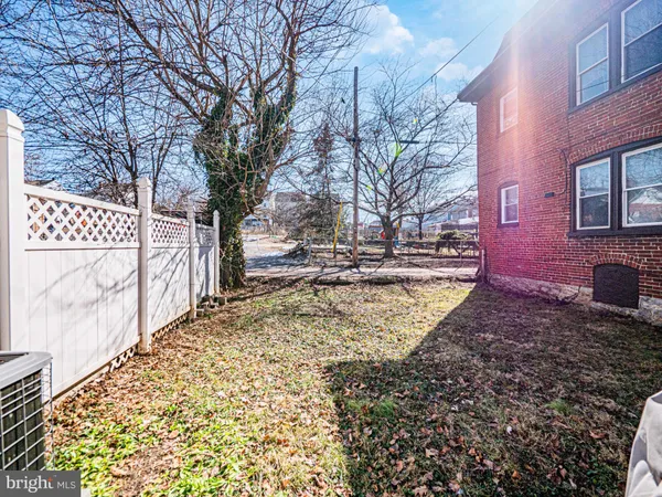 a view of a yard with brick walls