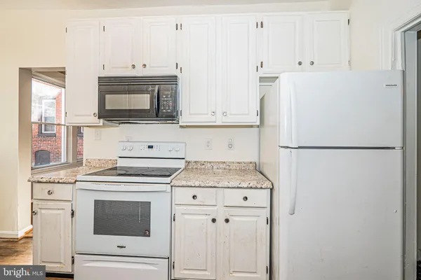 a kitchen with a stove microwave and refrigerator
