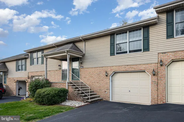 a view of a house with garage and yard