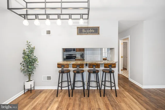 a view of a dining room with furniture and wooden floor