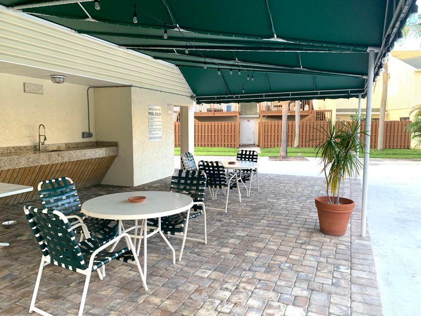 645 Executive Center Drive, Unit R202 West Palm Beach, FL 33401 - Photo 20 of 21 PATIO BY THE POOL
