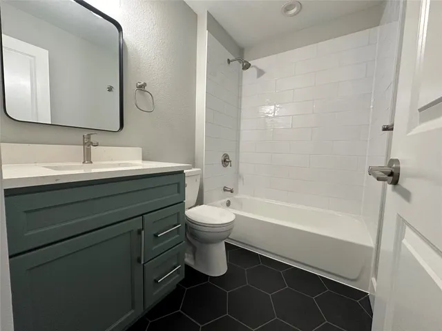 a bathroom with a double vanity sink toilet mirror and bathtub