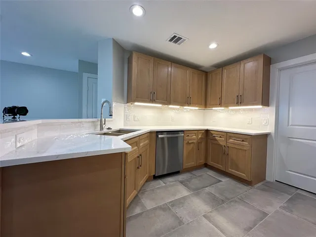 a kitchen with a sink a stove and cabinets