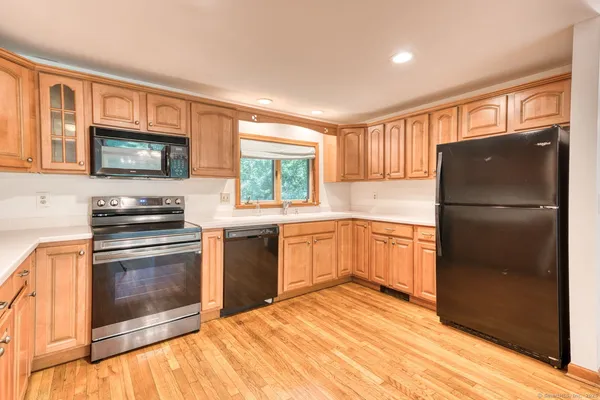 a kitchen with a refrigerator stove and microwave