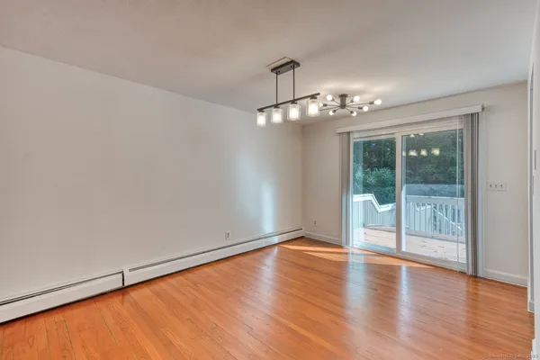 a view of a livingroom with wooden floor and a large window