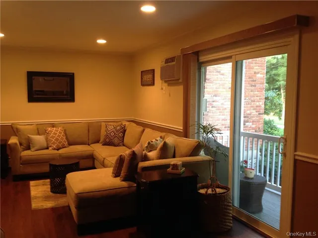 a living room with furniture and a floor to ceiling window