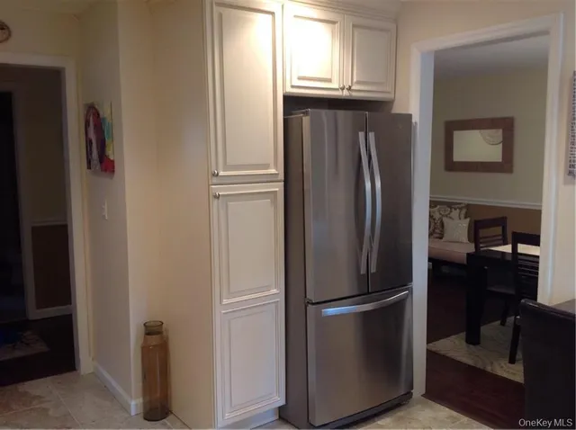 a metallic refrigerator freezer sitting in a kitchen