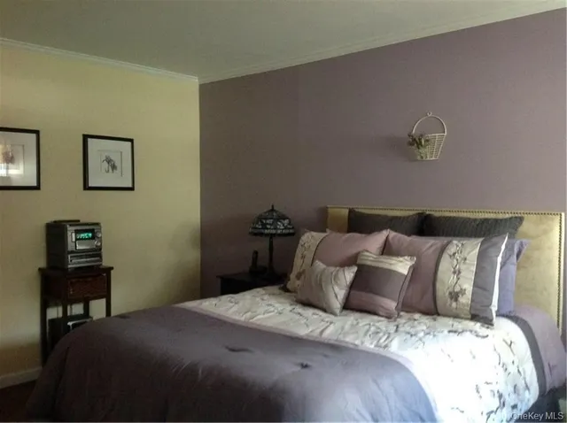 a bedroom with a bed and a table in it