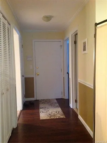 a view of room with window and wooden floor