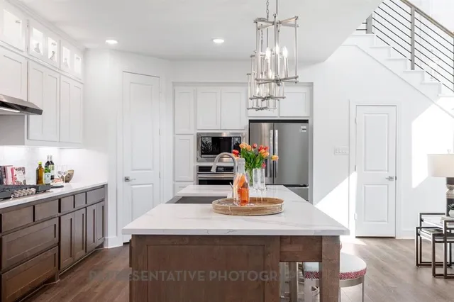 a kitchen with kitchen island a sink and appliances