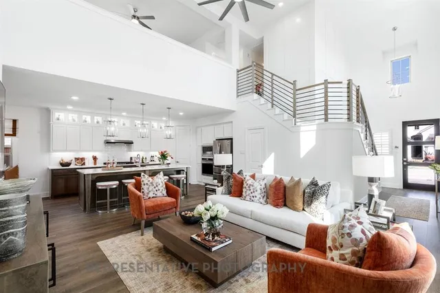 a living room with furniture kitchen view and a table