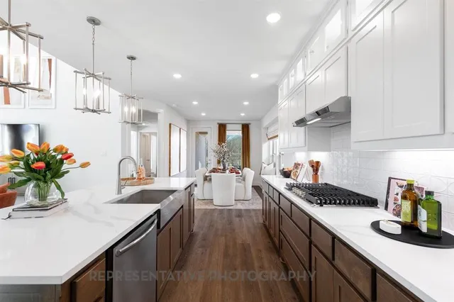 a kitchen with counter top space and wooden floor
