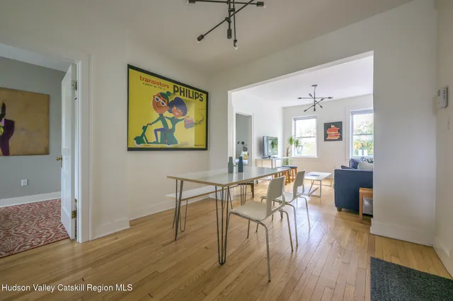 a view of a dining room with furniture and wooden floor