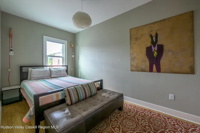 a bedroom with a bed and window