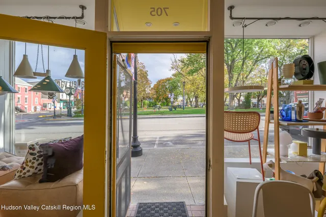 a balcony view with a fireplace and a large window