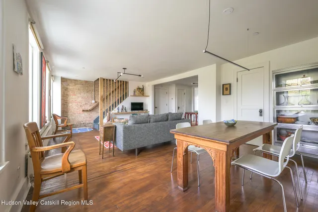 a view of a livingroom with furniture and a table