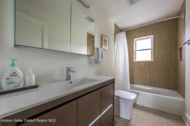 a bathroom with a sink a toilet and bathtub