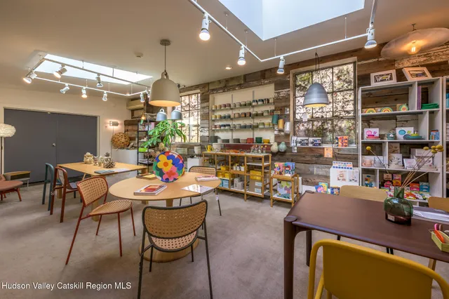 a outdoor dining space with furniture and a chandelier