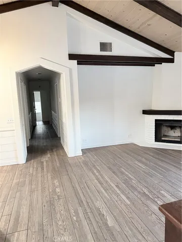 a kitchen with a stove and a wooden floors