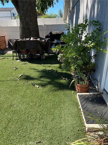 a view of a house with backyard sitting area and garden