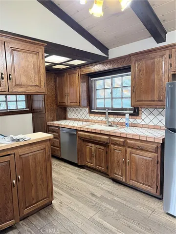 a view of a big room with windows and chandelier