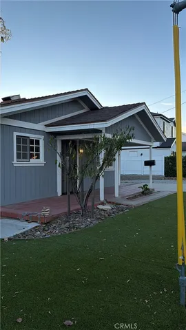 a front view of a house with a garden