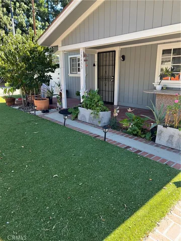 a front view of a house with a yard and seating space