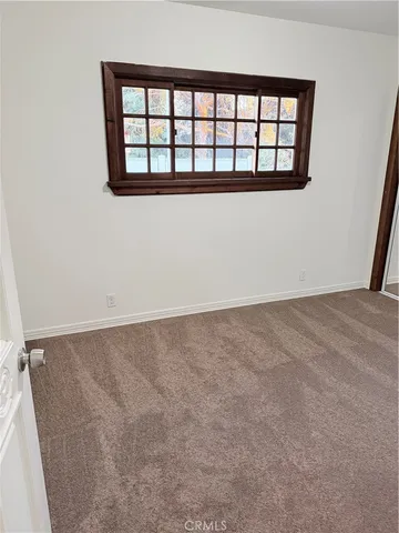 a view of a room with wooden floor and fan