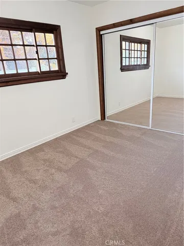 a white house that has a tree in front of it