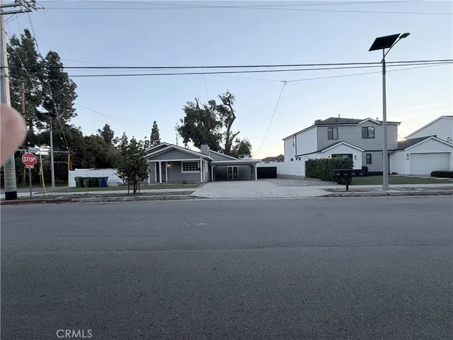 a view of empty room with wooden floor and fireplace
