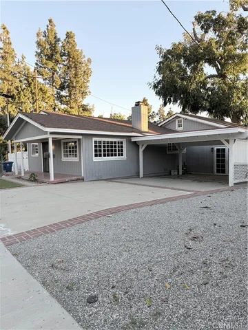 a view of a big room with wooden floor and windows
