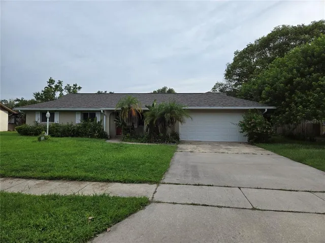 a front view of a house with a yard and a garage
