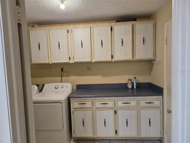 a view of cabinets with washer and dryer