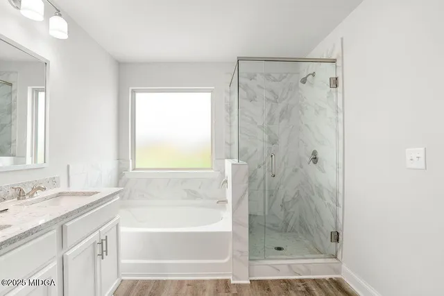 a bathroom with a granite countertop shower sink and a bathtub