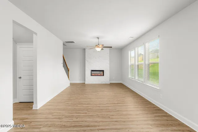wooden floor in an empty room with a window