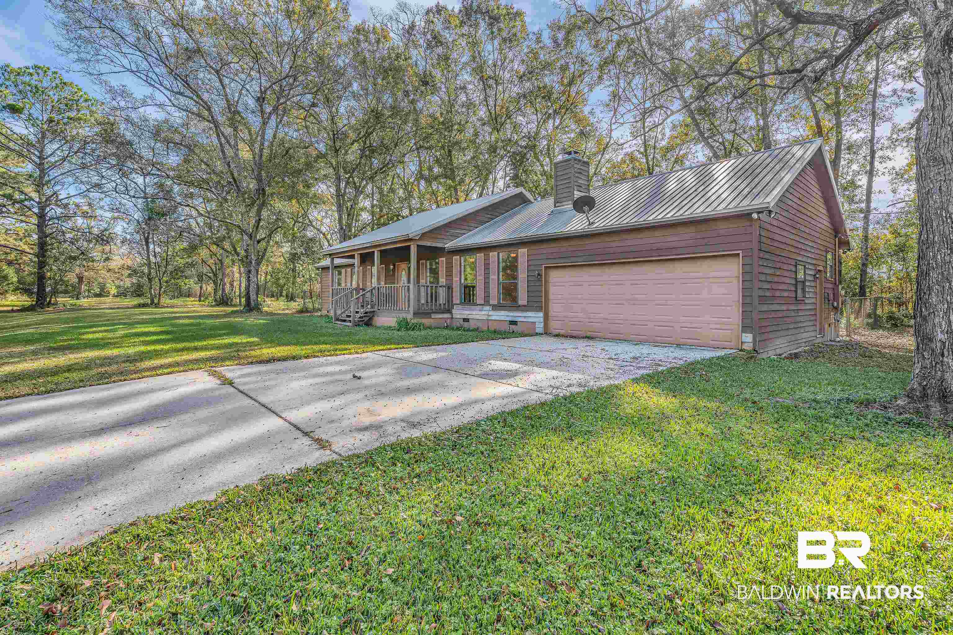 7787 Bellingrath Road Theodore, AL 36582 - Photo 6 of 36 View of front of property featuring a metal roof, driveway, a chimney, a front lawn, and crawl space