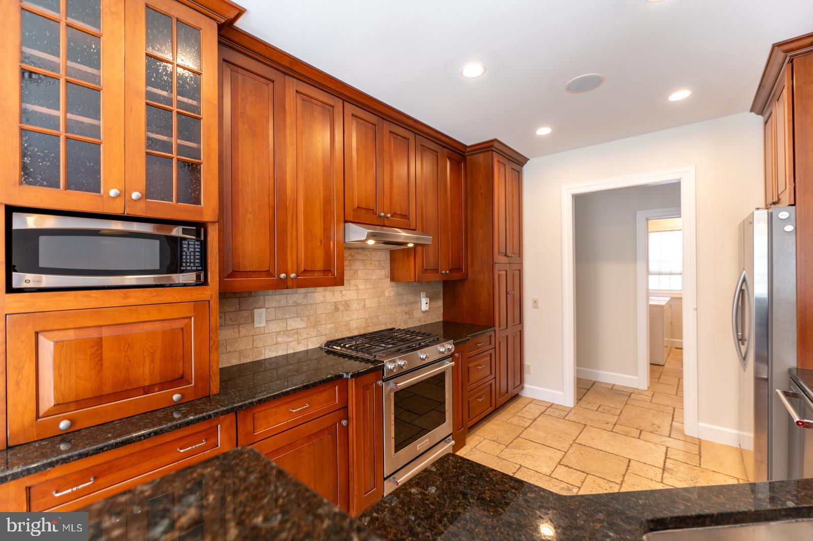 1060 West King Road Malvern, PA 19355 - Photo 18 of 90 a kitchen with stainless steel appliances granite countertop a stove a sink and a microwave