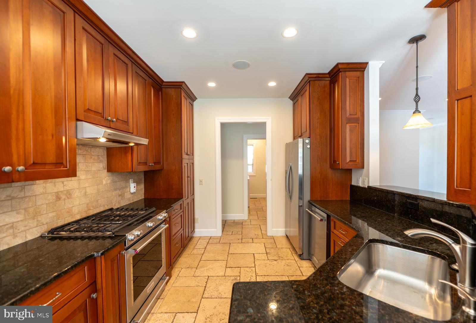 1060 West King Road Malvern, PA 19355 - Photo 24 of 90 a kitchen with stainless steel appliances granite countertop a stove a sink and a refrigerator